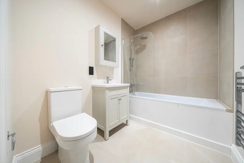 Family bathroom with beige porcelain tiling