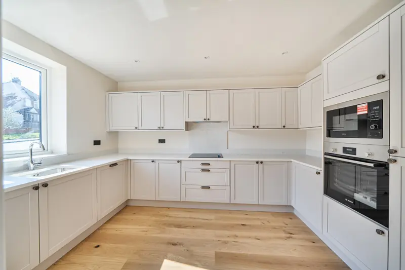 Shaker-style kitchen with integrated oven and microwave