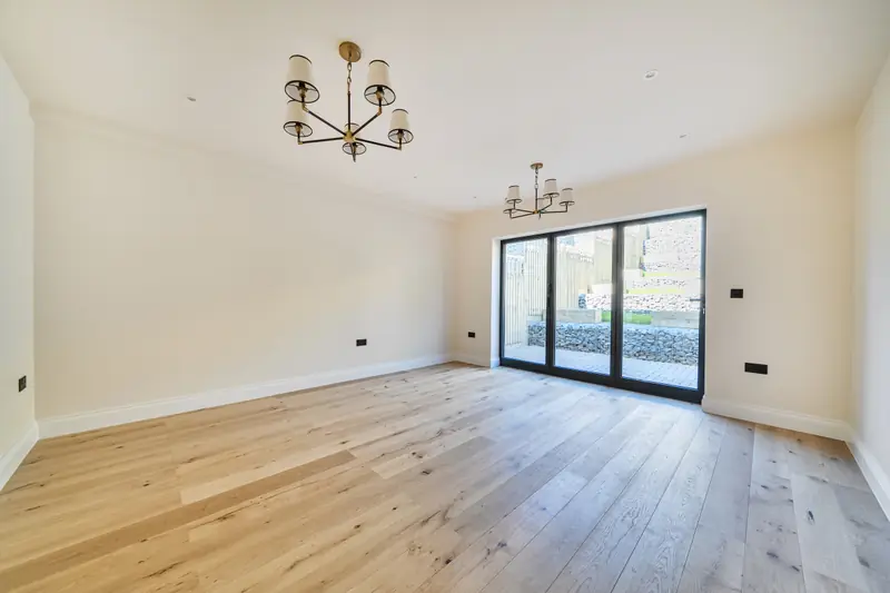 Living and dining room with bi-fold doors to the garden