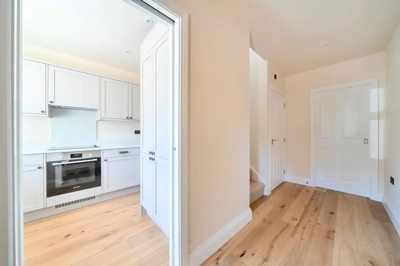 Entrance hallway with oak flooring, looking through to the kitchen