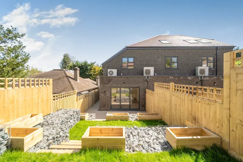 Rear garden with raised planters, looking back towards the terrace
